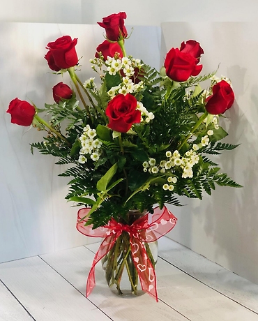 one dozen red roses in a vase