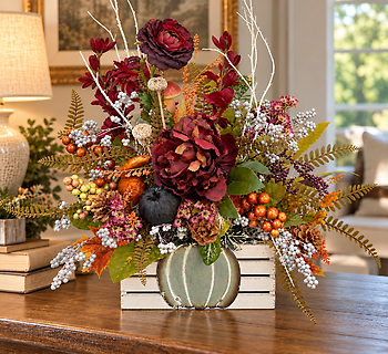 Fall arrangement in a pumpkin crate
